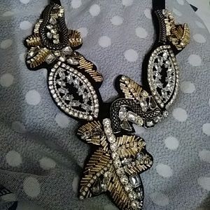 Black, gold and crystal necklace with lace up clos